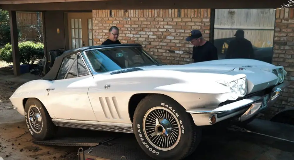 Loading a white 1966 Chevy Corvette Convertible onto a trailer, front quarter view