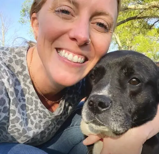 girl hugging a dog