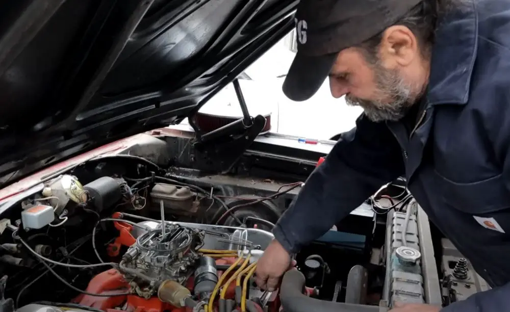 Tony DeFeo works on restarting his 1967 Dodge Charger