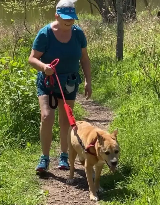 woman hiking with dog