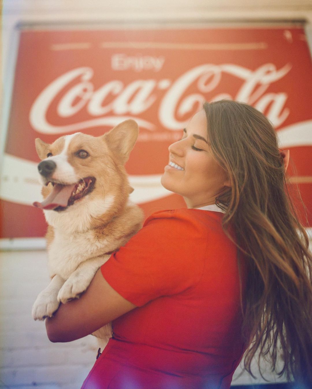 woman holding corgi